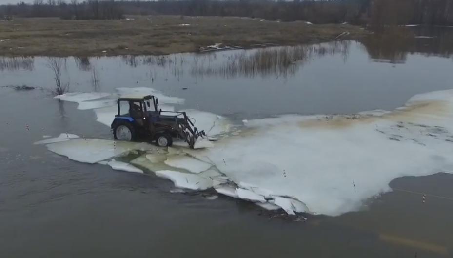 Aerial Images of a Tractor Breaking the Ice on a Flooded Road in Russia